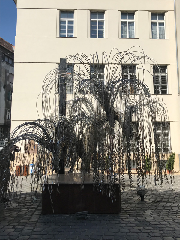 A metal sculpture of the Holocaust Tree of Life in the memorial garden at the Dohaney Street Synagogue. Names of 600,000 are engraved on the leaves and it serves as a memorial to Hungarian Jews who gave their lives during World War II. (photo by Anne Siegel)