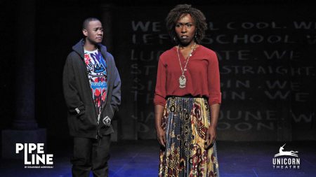 Nya and her son Omari speak on stage in a scene from Pipeline
