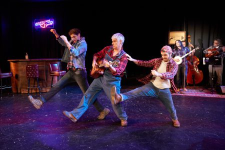 Three men in southern style outfits dance