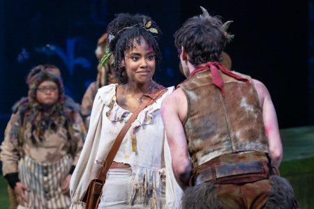 A young Black woman (Wendy) stares daggers at a white boy (Peter) seen from behind.