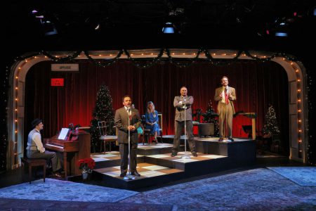 A group of actors perform a live radio play on a stage.