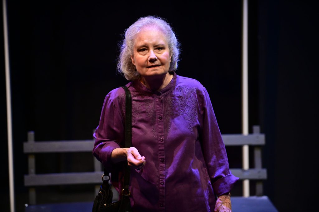 An older woman looks wistful