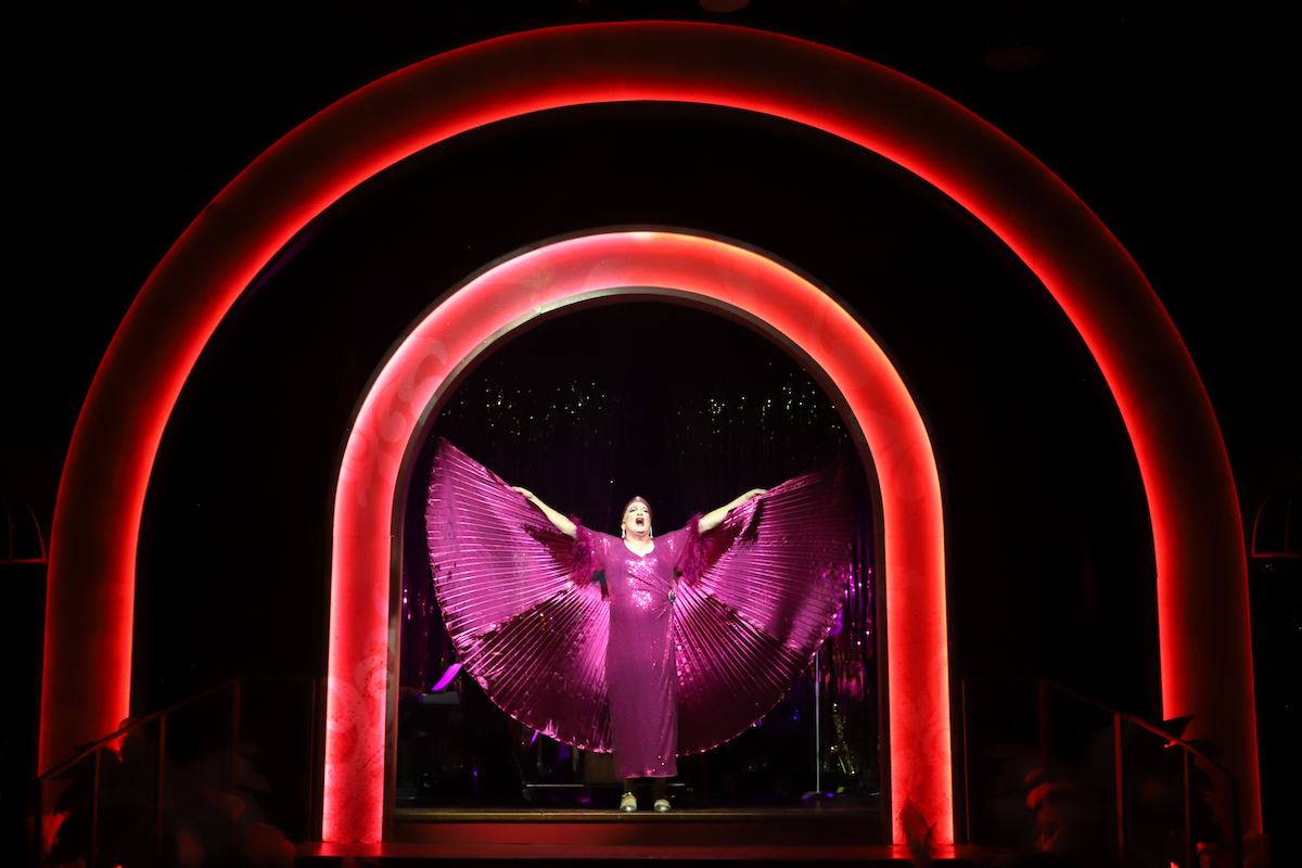 A drag artist performs onstage