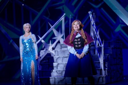 Elsa looks at Anna in a scene from Frozen.